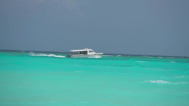 Luxury yacht cruising out at sea. Aerial view of luxury yacht cruising in turquoise lagoon. Aerial drone tracking video of luxury boat. Motor Yacht sailing on open ocean
