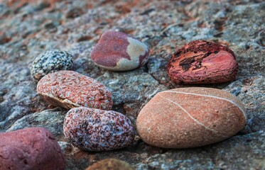 close up of a pile of red and black stones