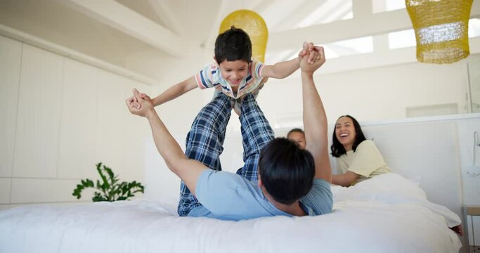 Father, boy and family on bed for airplane games, excited and holding hands for safety in house. Parents, children and lift with connection, love and plane for morning on holiday in home bedroom