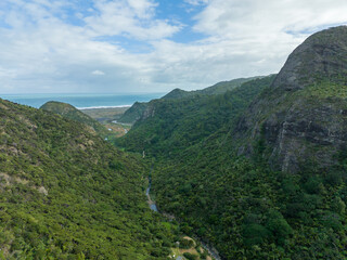 Naklejka premium Aerial: Forest and river in Pararaha Valley, Waitakere Ranges, KareKare, Auckland, New Zealand.