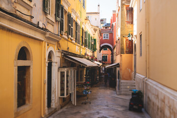 Fototapeta na wymiar Corfu street view, Kerkyra old town beautiful cityscape, Ionian sea Islands, Greece, a summer sunny day, pedestrian streets with shops and cafes, architecture of historic center, travel to Greece