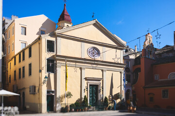 Obraz premium Corfu street view, Kerkyra old town beautiful cityscape, Ionian sea Islands, Greece, a summer sunny day, pedestrian streets with shops and cafes, architecture of historic center, travel to Greece