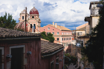 Fototapeta premium Corfu street view, Kerkyra old town beautiful cityscape, Ionian sea Islands, Greece, a summer sunny day, pedestrian streets with shops and cafes, architecture of historic center, travel to Greece