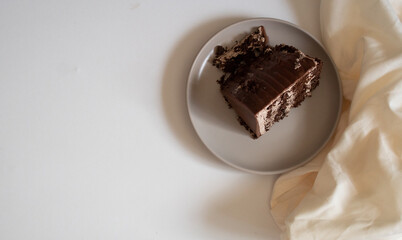 Top view of chocolate cake with chocolate cream on a plate