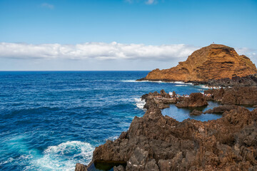 Rocky cliffs touching the immensity of the ocean.
