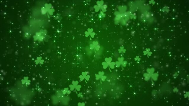 Lucky shamrocks, shiny stars and glowing glittering particles on a dark green gradient background. This Saint Patrick's Day celebration party background animation is full HD and a seamless loop.
