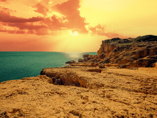 Rocky coast at sunset. Praia da Marinha beach in the Algarve region in the Atlantic Ocean,...