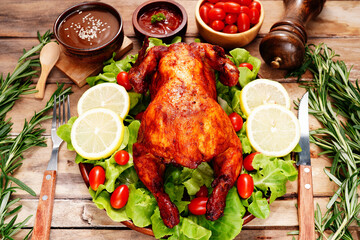 Grilled chicken marinated with mixed herbs, rosemary leaves, black pepper, lemon , seeds, celebration food On the old wooden table