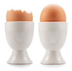 Brown soft-boiled chicken eggs in the egg cups isolated on white background. File contains clipping paths.