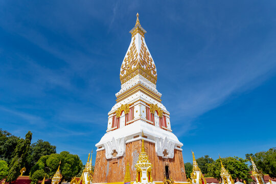 White gold pagoda with blue sky as background, Wat Phra That Phanom is a Buddhist temple in the That Phanom District in the south of Nakhon Phanom Province, Isan region of Thailand near the Lao border