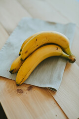 Close-up of a bunch of bananas on a wooden kitchen table background