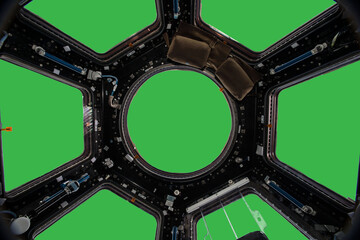 Porthole of space station isolated on green background. Elements of this image furnished by NASA.