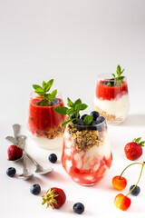 Healthy delicious breakfasts, glasses with muesli and yogurt, blueberries and strawberry smoothies, healthy breakfasts with seasonal berries