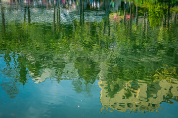 Botanical gardens and Trauttmansdorff Castle are reflected in the pond. Merano (South Tyrol), Trentino Alto Adige, northern Italy, Europe, May 13, 2023 - obrazy, fototapety, plakaty