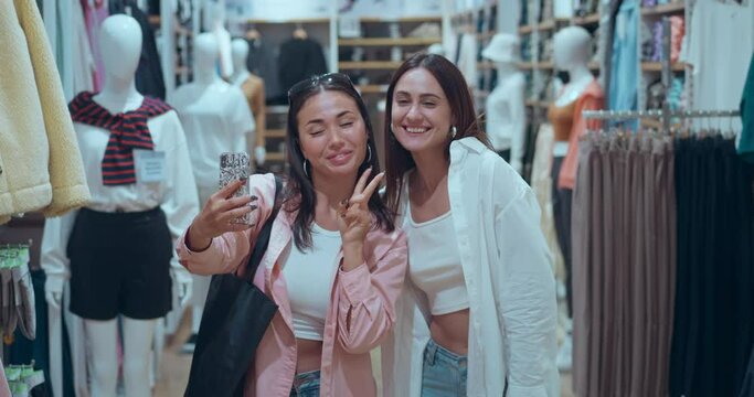 In mall clothing store friends make selfies share joy Women's happiness found style shopping sprees. Women's happiness selecting chic attire celebrating life Women's happiness laughter bonding.