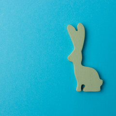 Easter bunny decoration on blue background. Minimal Easter concept.