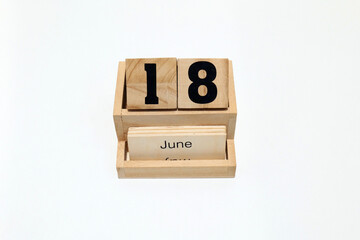 18th of June wooden perpetual calendar. Shot close up isolated on a white background