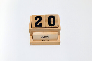 20th of June wooden perpetual calendar. Shot close up isolated on a white background