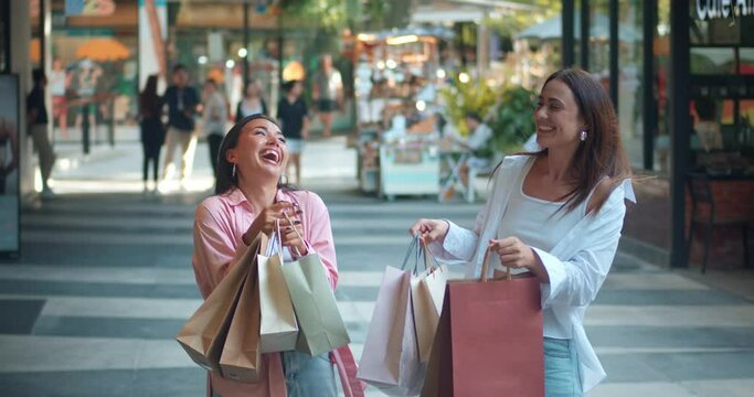 Friends mall showcasing shopping bags filled women's laughter. Women's laughter expression joy feminine charm Women's laughter amidst shopping epitome positive vibes Sparkling with happiness.