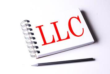 Text LLC on notebook on the white background, business