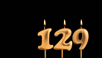 Birthday candle number 129 - Birthday celebration on black background