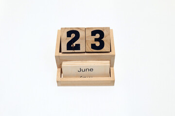 23rd of June wooden perpetual calendar. Shot close up isolated on a white background