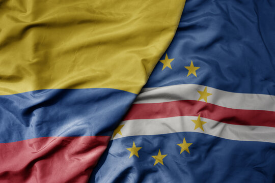 big waving national colorful flag of cape verde and national flag of colombia .