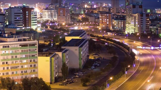 Twilight Transformation: Aktau City on Caspian Sea Shore Day to Night Timelapse. Aerial Top View, Capturing the City's Transition From Dusk to Nightfall, Along Kazakhstan's Coastal Beauty