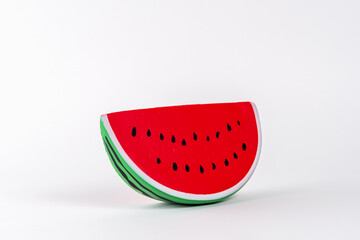 Trendy sunlight summer background with watermelon fruit on white backdrop. Minimal summer concept.