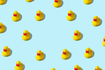 Creative pattern with rubber duck on blue background. Minimal summer concept.