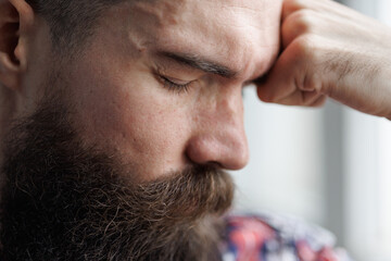 Obraz premium Brutal man with emotion of disappointment and depression on gray background. 