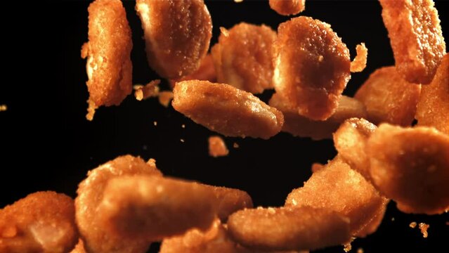 Chicken nuggets fly up and fall down. Filmed on a high-speed camera at 1000 fps. High quality FullHD footage