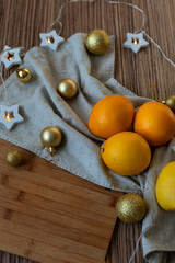New Year's layout of oranges, board, napkins, garlands and balloons on the kitchen table.Preparations for the holiday.Preparing for the celebration of Christmas.The concept of a cozy kitchen