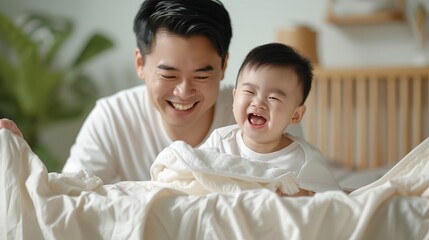 A helpful son assists his father in loading dirty laundry into the washing machine