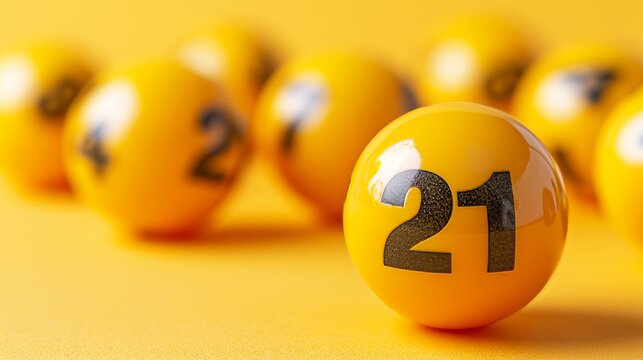 Close up of yellow lottery balls on pastel background, with lucky number 21 in focus