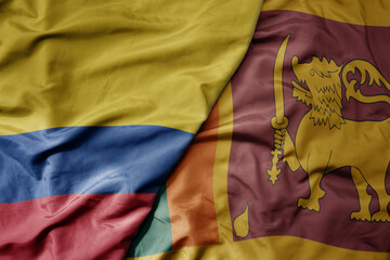 big waving national colorful flag of sri lanka and national flag of colombia .