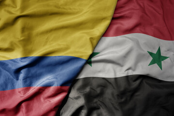 big waving national colorful flag of syria and national flag of colombia .