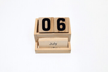 6th of July wooden perpetual calendar. Shot close up isolated on a white background