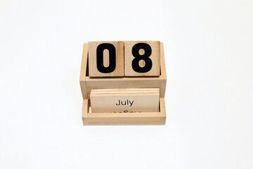 8th of July wooden perpetual calendar. Shot close up isolated on a white background