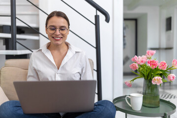 Woman freelancer working online in home interior.