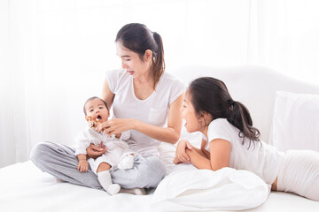 Selective focus young Asian beautiful mother hold newborn baby 0-1 month in her arms with love,...