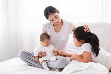 Selective focus young Asian beautiful mother hold newborn baby 0-1 month in her arms with love,...