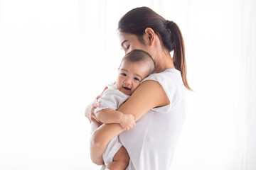 Selective focus young Asian beautiful mother hold newborn baby 0-1 month in her arms with love,...