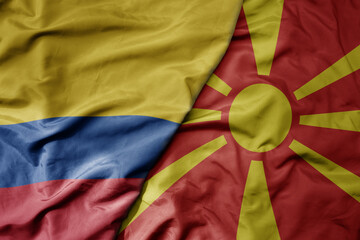 big waving national colorful flag of macedonia and national flag of colombia .