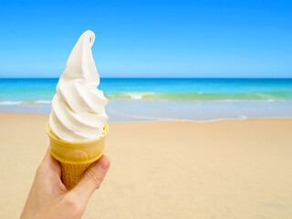 Hand holding vanilla soft serve ice cream