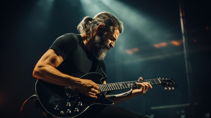 A bearded musician plays a guitar on stage.