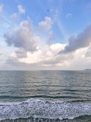 Sea with bird blurred on sky. Ocean waves and evening sky with birds flying in the distance Above the sky. natural scenery for background, vacation. 