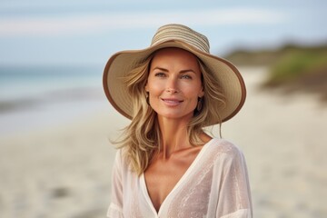 summer holidays, vacation, travel and people concept - smiling woman in hat and dress on beach