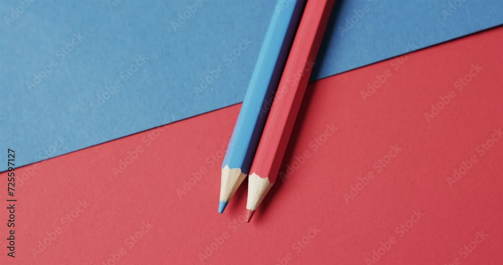 Canvas Prints Overhead view of blue and red crayons on red and blue background, in slow motion