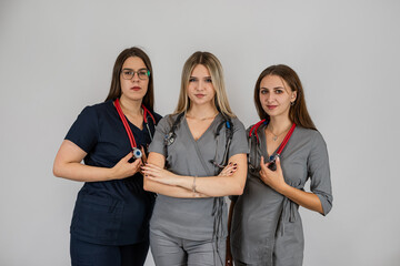 Medical team with three woman doctor  standing together at isolated background